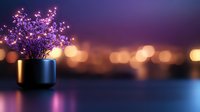 Glowing purple flowers in black vase against blurred city lights background create romantic evening atmosphere with soft bokeh effect and reflective surface.