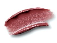 Smeared dark rose lipstick swatch showing creamy texture and glossy finish on white background, isolated cosmetic product sample for makeup artists and beauty brands.