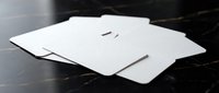 Stack of blank white business cards mockup on dark marble surface for corporate branding and professional identity design projects.