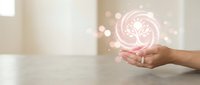 Female hand holding glowing pink brain icon with neural network connections representing artificial intelligence and mental health concepts.
