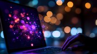 Digital technology concept with glowing particles and bokeh lights on laptop screen creating futuristic atmosphere for tech presentations.