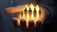 Human resources management concept with glowing silhouettes of diverse professionals standing on open palm representing team leadership and talent development.