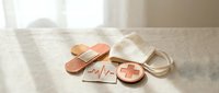 Copper-colored medical bandages with heartbeat line and cross symbols on white surface for healthcare design projects.