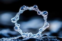 Clear dental aligner orthodontic treatment device on dark background with dramatic lighting for healthcare and dentistry concepts.