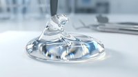 Clear liquid splash frozen in mid-air on white surface with office background, suitable for skincare, cosmetics, and product advertising campaigns.