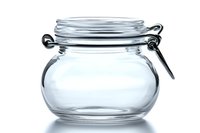 Empty glass jar with swing top lid and wire bail closure on white background, isolated preserving container for food storage and canning projects.