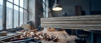 Traditional woodworking workshop with vintage hand tools, wooden planks and warm lighting creating authentic craftsmanship atmosphere for artisan projects.