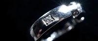 Elegant silver wedding band with sparkling diamond accent on dark background, luxury jewelry for engagement and marriage ceremonies.