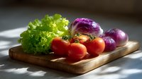 Fresh vegetables on wooden cutting board with dramatic lighting - red tomatoes on vine, purple onions and green lettuce leaf create appetizing composition.