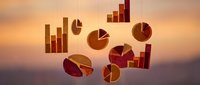 Floating golden pie charts and bar graphs suspended against a warm sunset sky, symbolizing financial growth, data analysis, and business success.