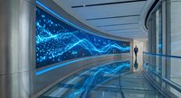 Futuristic corridor with glowing blue digital wave display on curved wall. Modern architecture with reflective floors and ambient lighting for tech concepts.