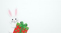 White rabbit holding red gift box with green bow on isolated background, suitable for Easter, holiday greeting cards, children's illustrations, and festive design projects.