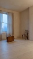 Minimalist empty room with wooden flooring, vintage leather suitcase and chair, sheer curtains framing large window with natural light, suitable for interior design, real estate, and lifestyle concepts.