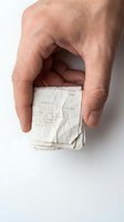 Male hand holding crumpled receipts against white background. Concept for expense tracking, financial management, accounting, budgeting, and business documentation.