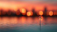 Tranquil sunset over water with blurred city lights and small wind turbine silhouette, creating atmospheric bokeh effect for environmental energy concepts.