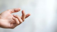 Open hand gesture reaching out with fingers extended in welcoming pose against soft neutral background for communication and connection concepts.