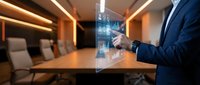 Professional businessman using holographic digital interface technology in modern conference room for business presentations and data analysis.