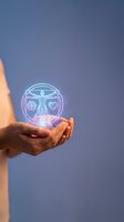 Hand holding glowing neon hologram sphere with human figure, brain and heart symbols representing health, wellness and medical technology concepts.