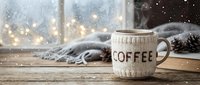 Cozy winter coffee mug in knitted sleeve on wooden table by snowy window with bokeh lights and pine cones, warm hygge atmosphere.