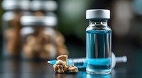 Medical vial with blue liquid and syringe on dark background with dried mushrooms. Healthcare and alternative medicine concept for pharmaceutical design.