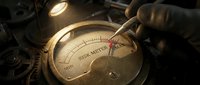 Vintage brass risk meter gauge with needle pointing to high danger zone, illuminated by warm light in steampunk industrial setting with mechanical gears and components.