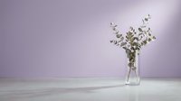 Minimalist eucalyptus branches in clear glass vase against soft purple wall creating serene home decor atmosphere for interior design projects.