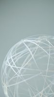 Abstract wireframe sphere with interconnected lines on soft gray background representing global network connectivity and digital communication.