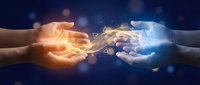 Two hands reaching toward each other with glowing energy and light effects connecting them, symbolizing partnership, collaboration and human connection.
