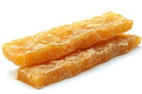 Crystallized sugar candy sticks in golden amber color on white background, traditional oriental sweet confection isolated for commercial food photography.