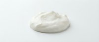 White creamy cosmetic product, moisturizer or skincare lotion sample isolated on white background for beauty and wellness design projects.