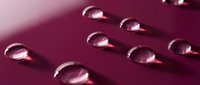 Clear gel capsules arranged in rows on a deep magenta surface with soft lighting and shadows, suitable for pharmaceutical, wellness, supplement, and healthcare marketing materials.