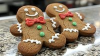 Freshly baked gingerbread men cookies decorated with colorful icing, featuring smiling faces, bow ties, and buttons on marble counter, holiday baking tradition.