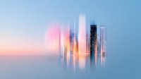 Abstract cityscape with blurred vertical motion effect showing modern skyscrapers against pastel sunset sky, creating dreamy urban reflection in soft pink and blue tones.