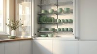 Modern kitchen cabinet with organized green ceramic dinnerware on illuminated shelves, showcasing contemporary storage solutions for home design.