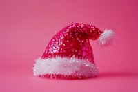 Sparkly red and pink glitter Santa hat with white fluffy trim isolated on pink background, ready for holiday design projects and festive graphics.