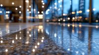 Modern office lobby with polished floor reflecting warm and cool lights during evening hours, suitable for corporate, business, and architectural design projects.