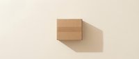 Closed cardboard box with shadow on neutral beige background, suitable for shipping, delivery, packaging design, and e-commerce applications.