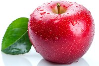 Fresh red apple with water drops and green leaf on white background, macro shot showing detailed texture and natural moisture for food and healthy lifestyle concepts.