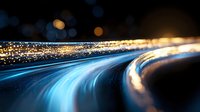 Glowing curved light trails with bokeh effects against dark background create dynamic motion and energy, suitable for technology and innovation concepts.