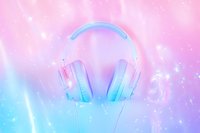 Modern wireless headphones in pastel pink and blue colors on dreamy gradient background with bokeh lights and sparkles, music and technology concept.