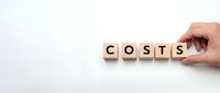 Hand placing wooden letter blocks spelling COSTS on white background for business expense and budget planning concepts.