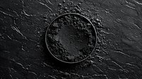 Black activated charcoal powder in round ceramic bowl on dark stone background, top view. Natural cosmetic and detox ingredient for spa treatments.