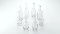 Collection of empty clear glass bottles in various shapes and sizes arranged on white background for packaging design and craft projects.