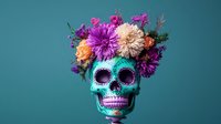Decorative turquoise skull adorned with vibrant fresh flowers including purple chrysanthemums, peach dahlias and greenery against teal background. Day of dead concept.