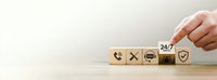 Professional customer service support concept with wooden blocks featuring contact icons and 24/7 availability symbol for business communication solutions.