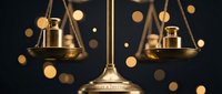 Golden scales of justice with balanced plates against dark background with warm bokeh lights for legal and law firm concepts.
