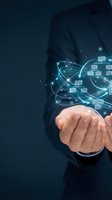 Businessman holding glowing digital network connections with data flow visualization representing cloud computing and modern technology solutions.