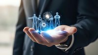Businessman holding holographic human resources icons with glowing digital network connections representing team management and corporate leadership solutions.