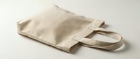 Blank natural canvas tote bag with handles isolated on white background, ready for custom printing, branding, and design projects.