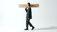 Young adult male, East Asian ethnicity, wearing formal black business attire, carrying large wooden plank on shoulder against white background. Represents burden, responsibility, hard work, and business challenges.